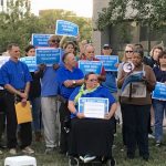 citizens with signs protesting the rate hike