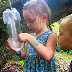 kid holding beetle trap