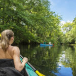 girl paddles on the river