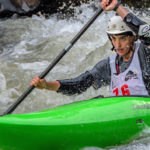 Kayaker paddles through rapid