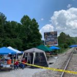 tents near train tracks