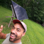 man by solar panel