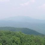 view of a mountain is partially obscured by white haze