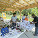 Men work with solar components