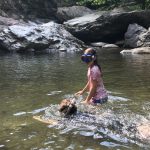 Two young snorkelers exploring a shallow river.