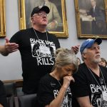 Images shows miners wearing black lung kills t-shirts lobbying Congress