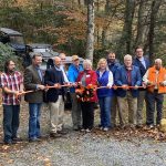 A group of locals and officials celebrate the opening of new Dante recreation area with a ribbon cutting ceremony.