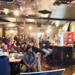 Several dozen men and women gather in a brewery to watch a presentation about the Ridgeline Pipeline Expansion project in Middle Tennessee.